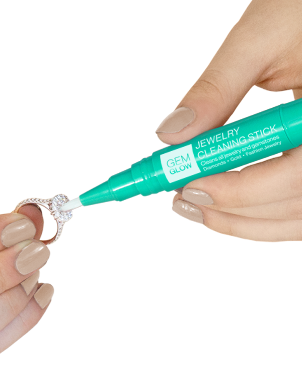 Hands cleaning a diamond ring with a Jewelry Cleaning Stick