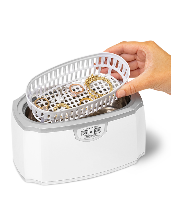 Hand holding accessory basket dipping it into the Professional Ultrasonic Machine