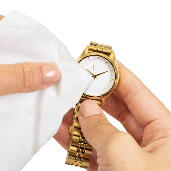 Jewelry cleansing wipe cleaning dirt off of a gold watch